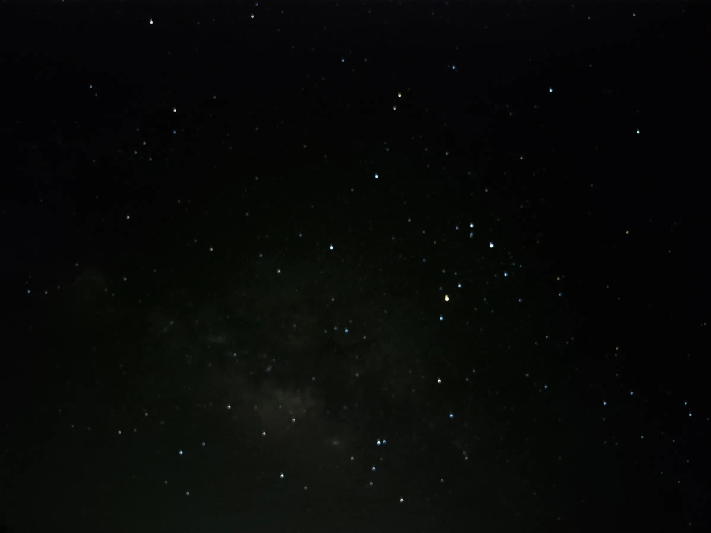 A dark night sky filled with countless stars of varying brightness. A faint, diffuse glow of the Milky Way is visible. Taken from a Samsung S23 FE phone.